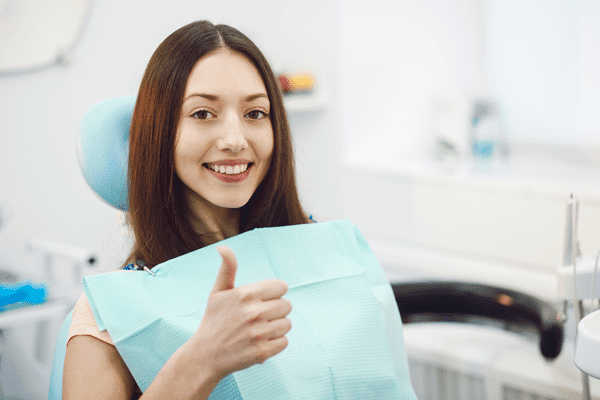 woman-in-dentist-chair-thumbs-up