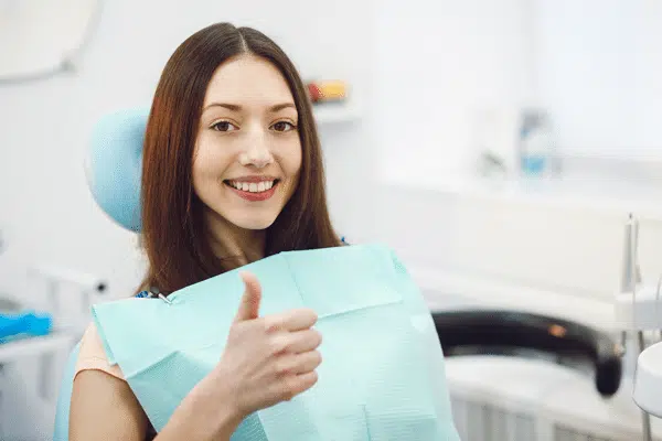 woman-in-dentist-chair-thumbs-up woman-in-dentist-chair-thumbs-up
