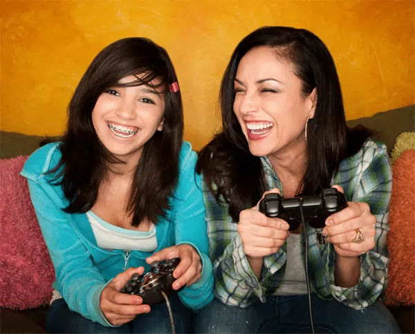 mom-and-daughter-smiling-playing-games mom-and-daughter-smiling-playing-games