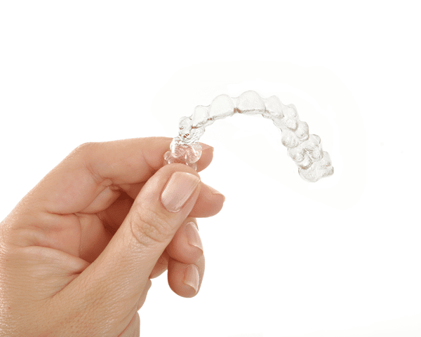 close-up-holding-invisalign-clear-aligners