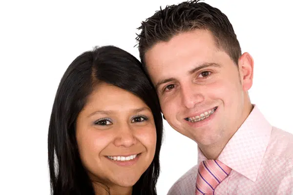 adult-couple-smiling-with-braces adult-couple-smiling-with-braces