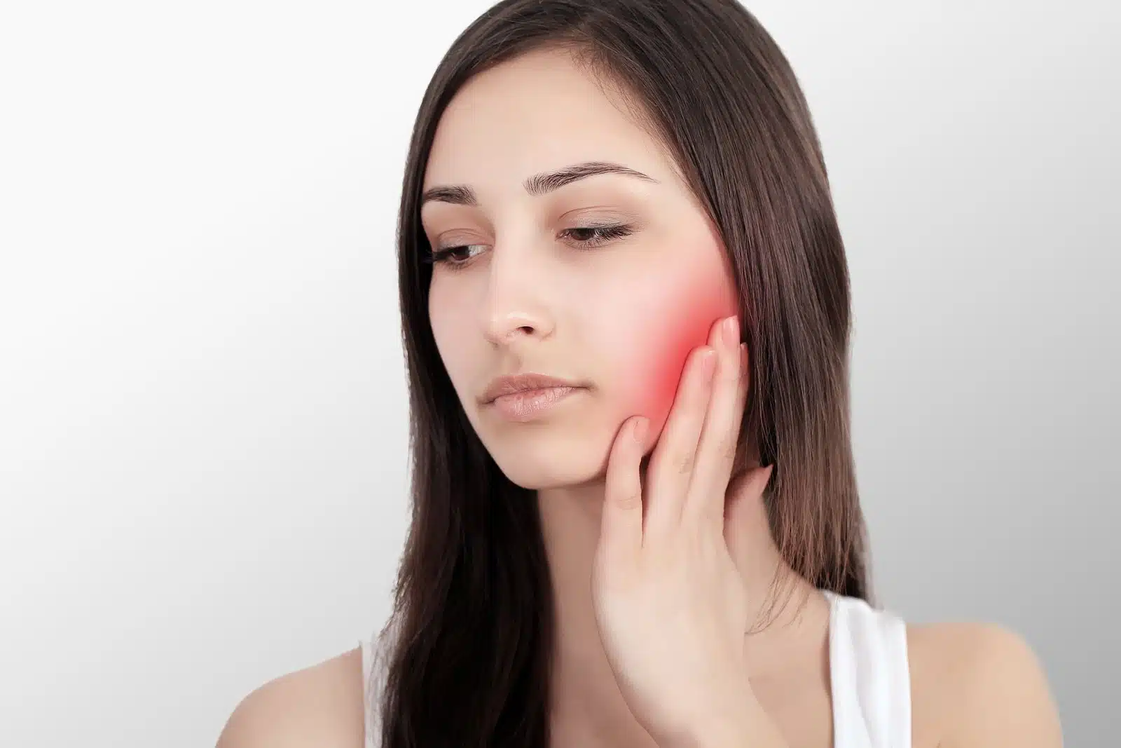 Woman In Pain. Closeup Of Beautiful Young Woman Feeling Painful Toothache, Touching Face With Hand